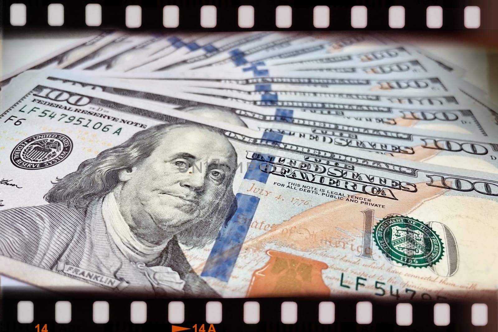 A Fan of $100 Bills.A close-up photo of a fan of $100 US dollar bills. The bills are arranged neatly, with the portrait of Benjamin Franklin visible on each bill. The background is white.Finance ve economy concept.