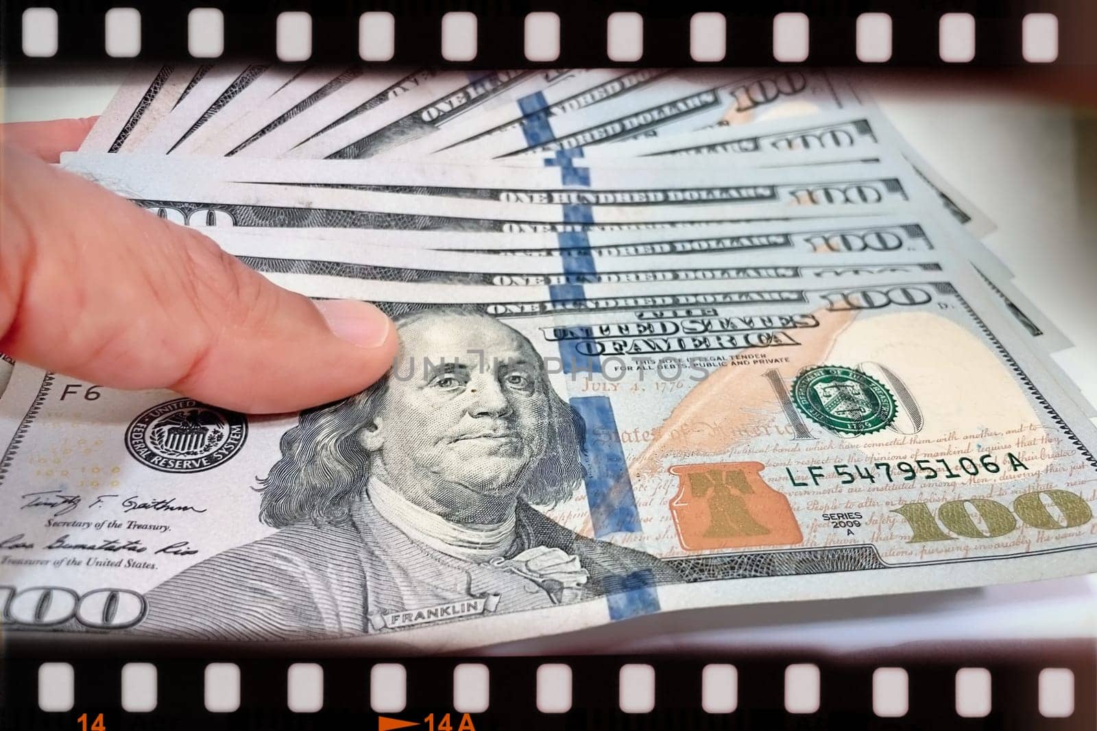 A Fan of $100 Bills.A close-up photo of a fan of $100 US dollar bills. The bills are arranged neatly, with the portrait of Benjamin Franklin visible on each bill. The background is white.Finance ve economy concept.