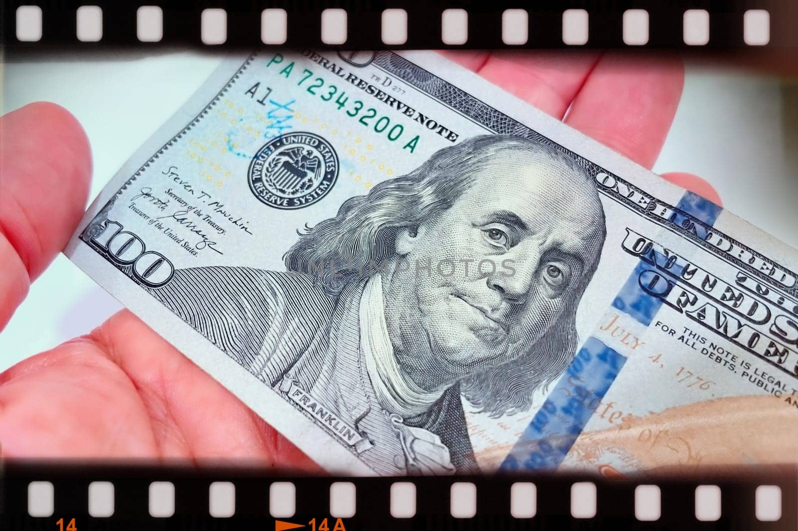 A Fan of $100 Bills.A close-up photo of a fan of $100 US dollar bills. The bills are arranged neatly, with the portrait of Benjamin Franklin visible on each bill. The background is white.Finance ve economy concept.