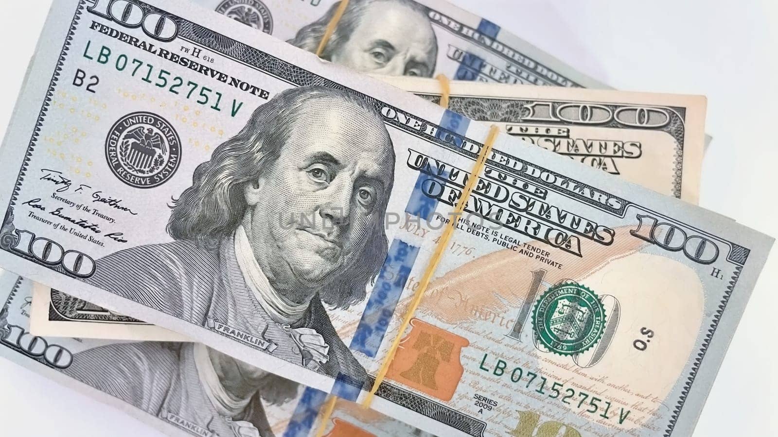 A Fan of $100 Bills.A close-up photo of a fan of $100 US dollar bills. The bills are arranged neatly, with the portrait of Benjamin Franklin visible on each bill. The background is white.Finance ve economy concept.