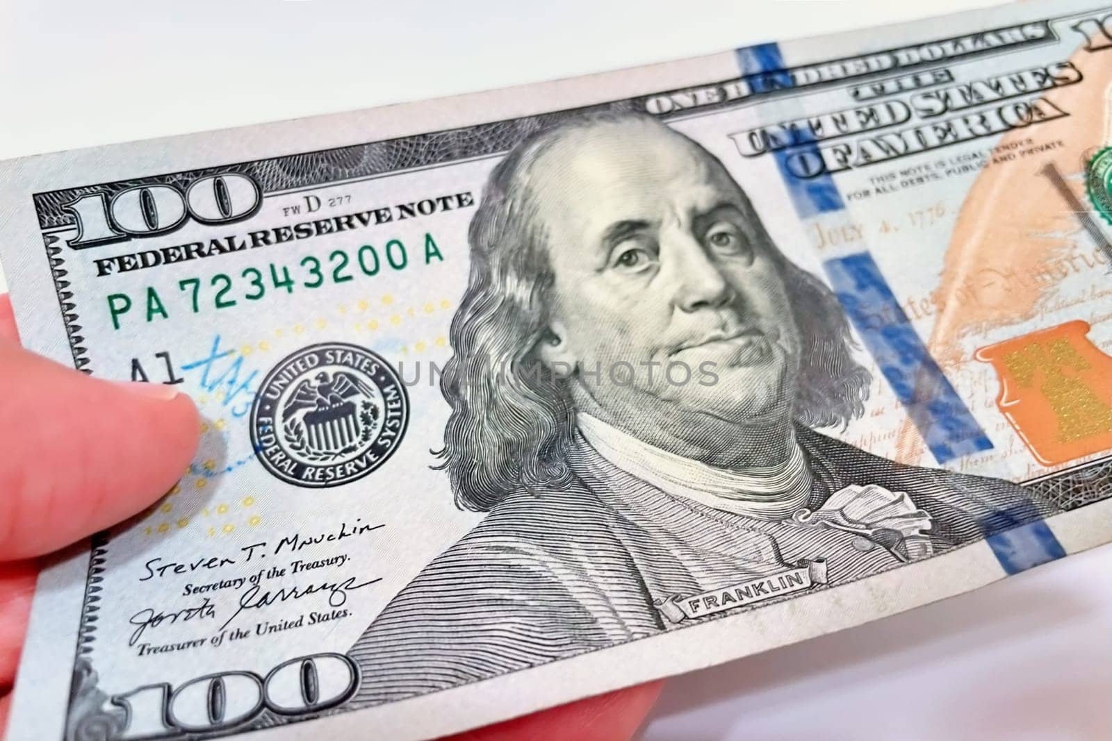 A Fan of $100 Bills.A close-up photo of a fan of $100 US dollar bills. The bills are arranged neatly, with the portrait of Benjamin Franklin visible on each bill. The background is white.Finance ve economy concept.
