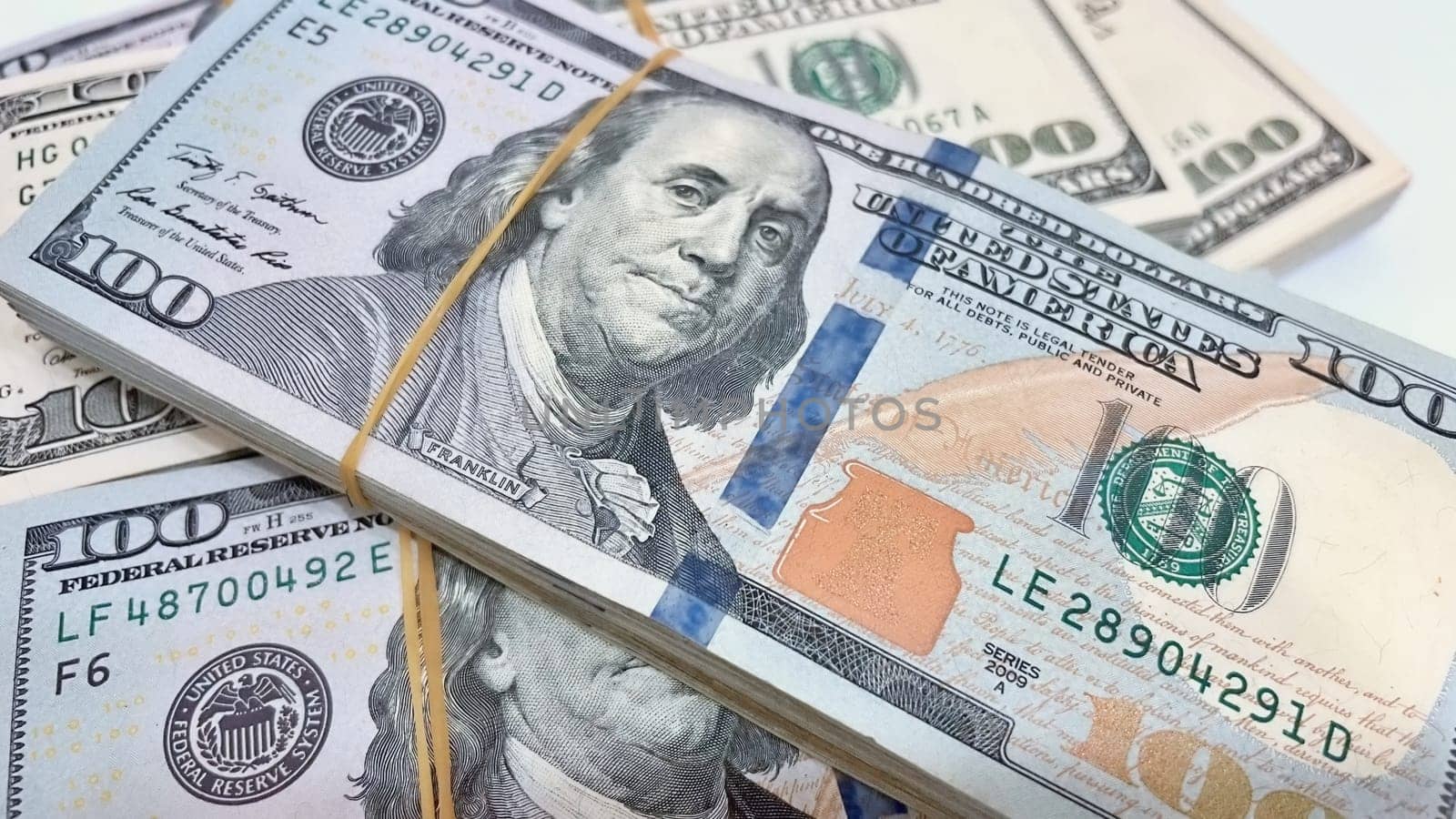 A Fan of $100 Bills.A close-up photo of a fan of $100 US dollar bills. The bills are arranged neatly, with the portrait of Benjamin Franklin visible on each bill. The background is white.Finance ve economy concept.