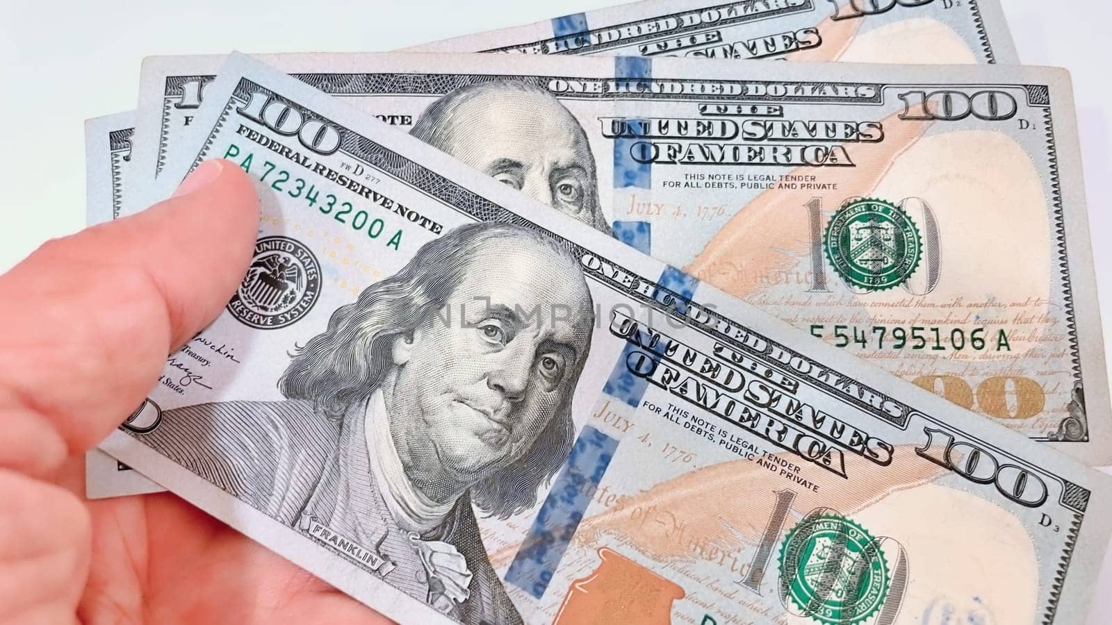 A Fan of $100 Bills.A close-up photo of a fan of $100 US dollar bills. The bills are arranged neatly, with the portrait of Benjamin Franklin visible on each bill. The background is white.Finance ve economy concept.