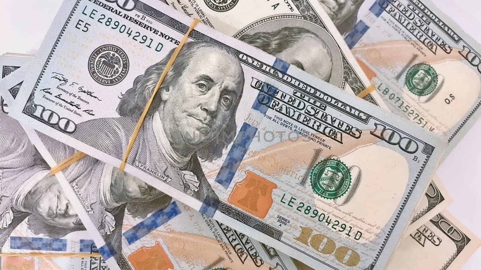 A Fan of $100 Bills.A close-up photo of a fan of $100 US dollar bills. The bills are arranged neatly, with the portrait of Benjamin Franklin visible on each bill. The background is white.Finance ve economy concept.