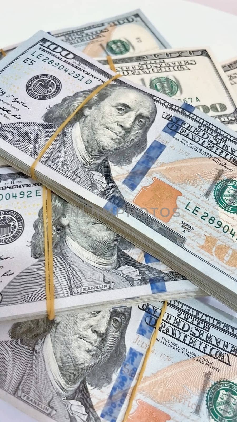 A Fan of $100 Bills.A close-up photo of a fan of $100 US dollar bills. The bills are arranged neatly, with the portrait of Benjamin Franklin visible on each bill. The background is white.Finance ve economy concept.