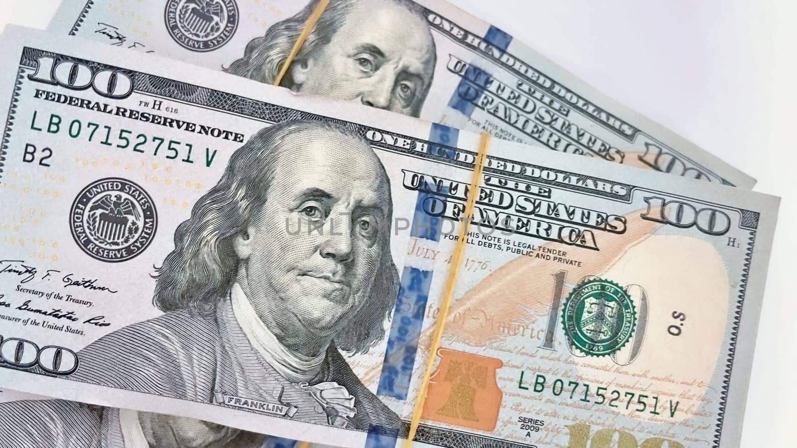 A Fan of $100 Bills.A close-up photo of a fan of $100 US dollar bills. The bills are arranged neatly, with the portrait of Benjamin Franklin visible on each bill. The background is white.Finance ve economy concept.