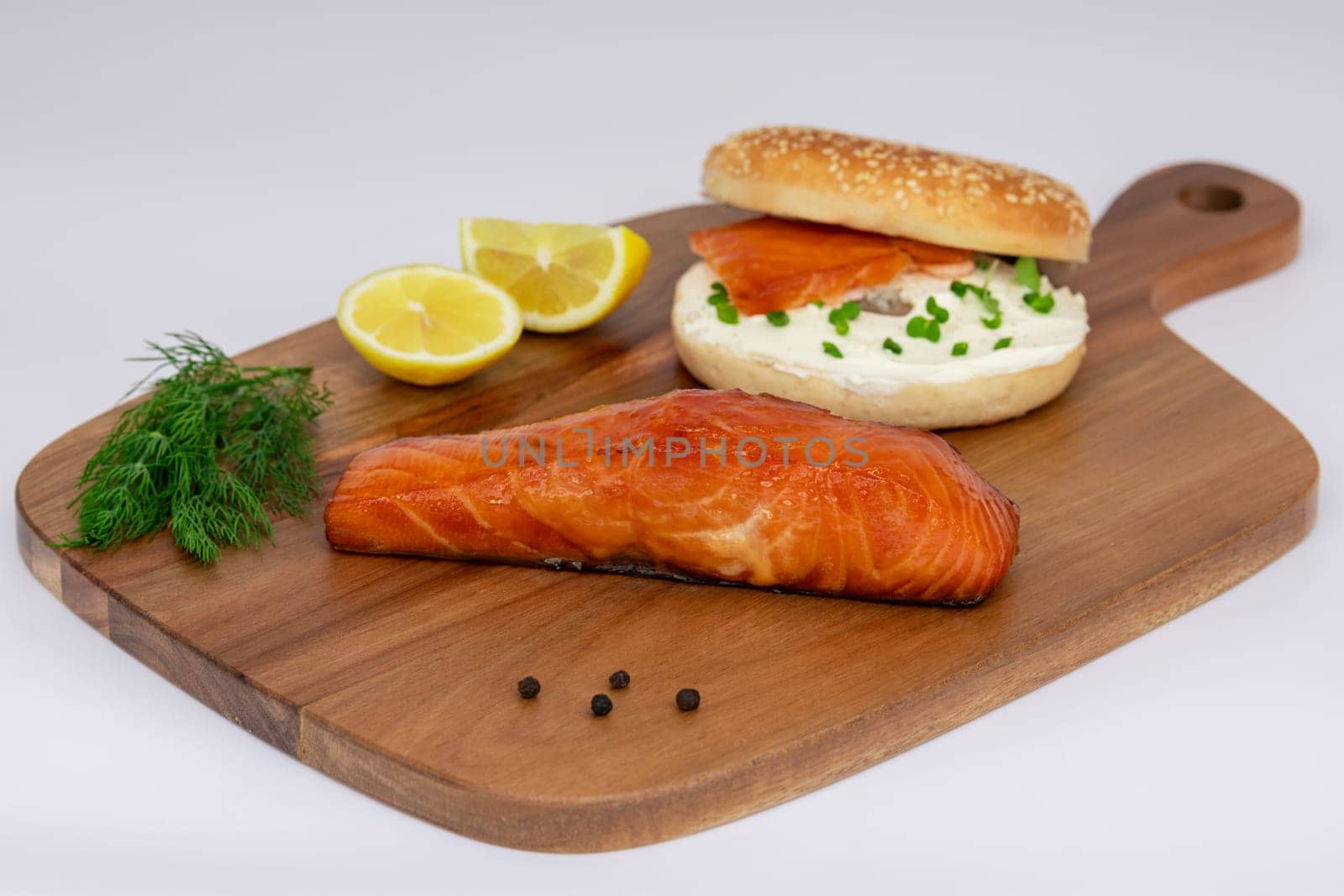 A truly delicious salmon bagel, beautifully served with fresh dill and zesty lemon, perfect for a gourmet meal