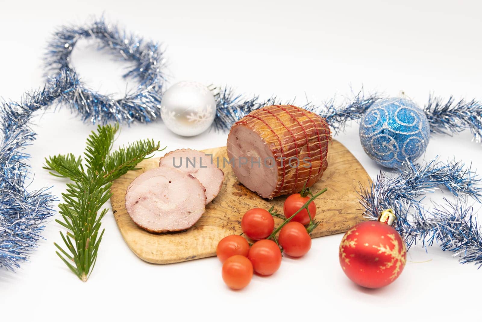 Smoked Turkey roll with herbs on a wooden background.