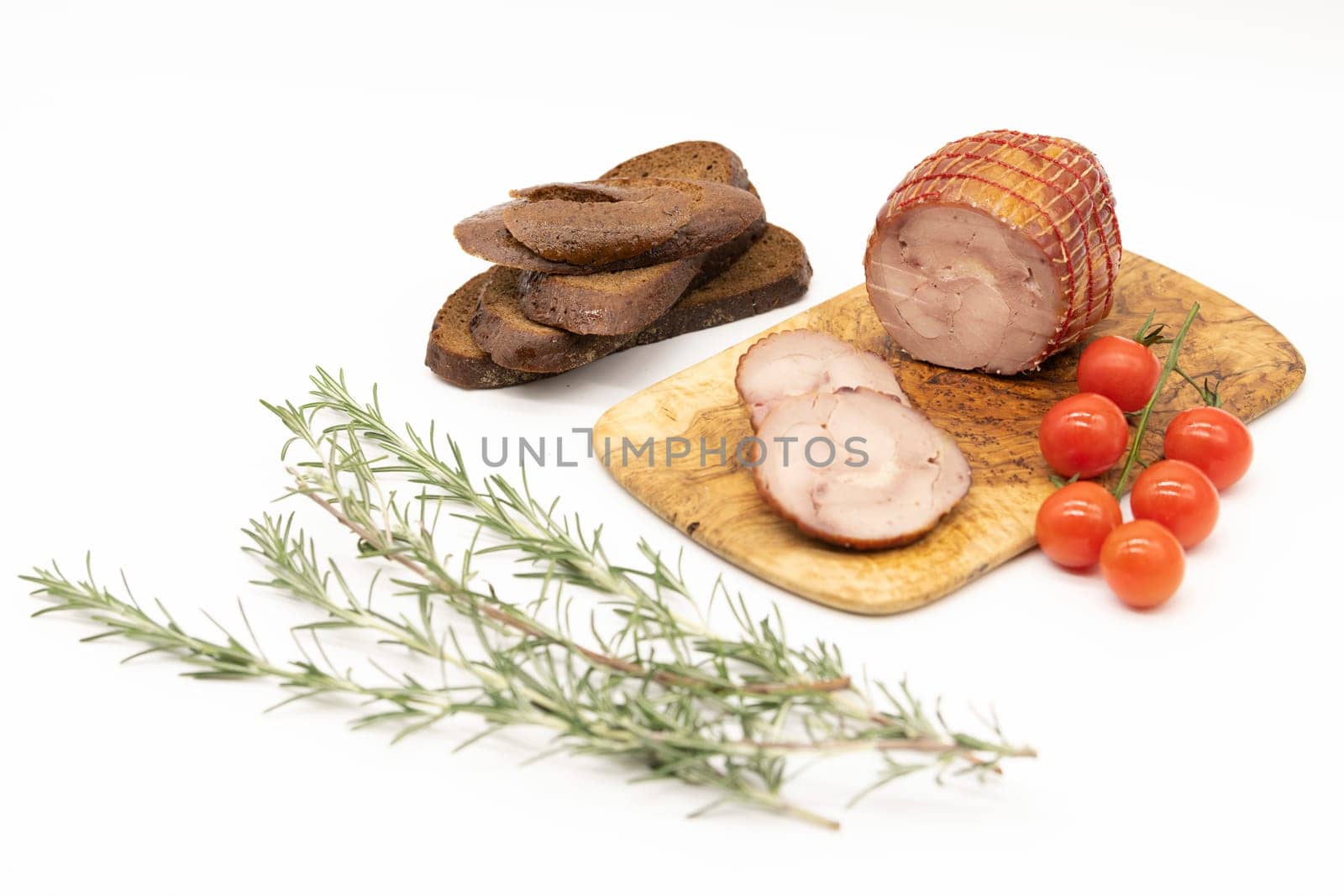 Smoked Turkey roll with herbs on a wooden background.
