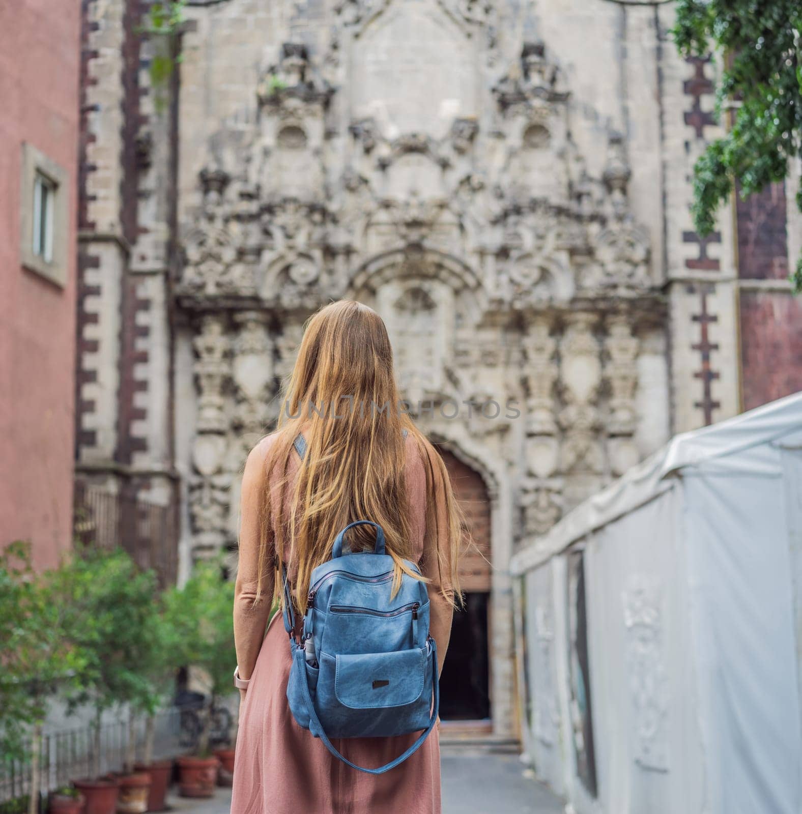 Female tourist in the central square of Mexico City, Zocalo. Cultural exploration, travel, and historic architecture concept.