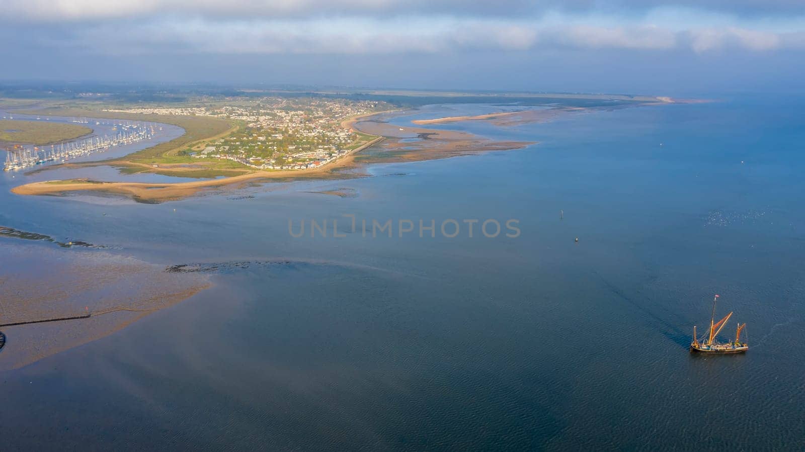 Beautiful aerial view on vintage caravel on sunlit sea water. Scenic travel concept, Brightlingsea, Essex, UK