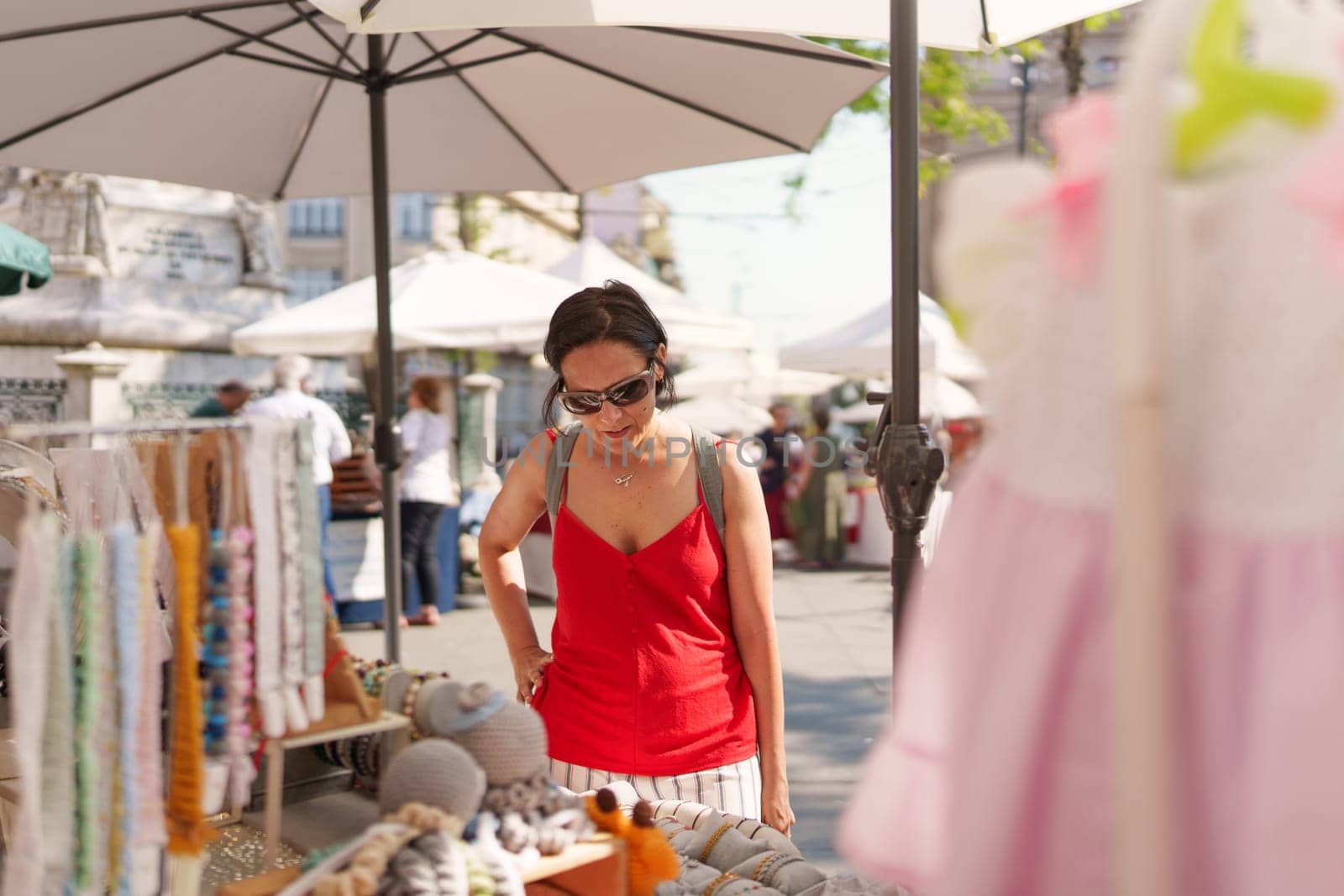 Woman looking at clothes at a street market, Porto