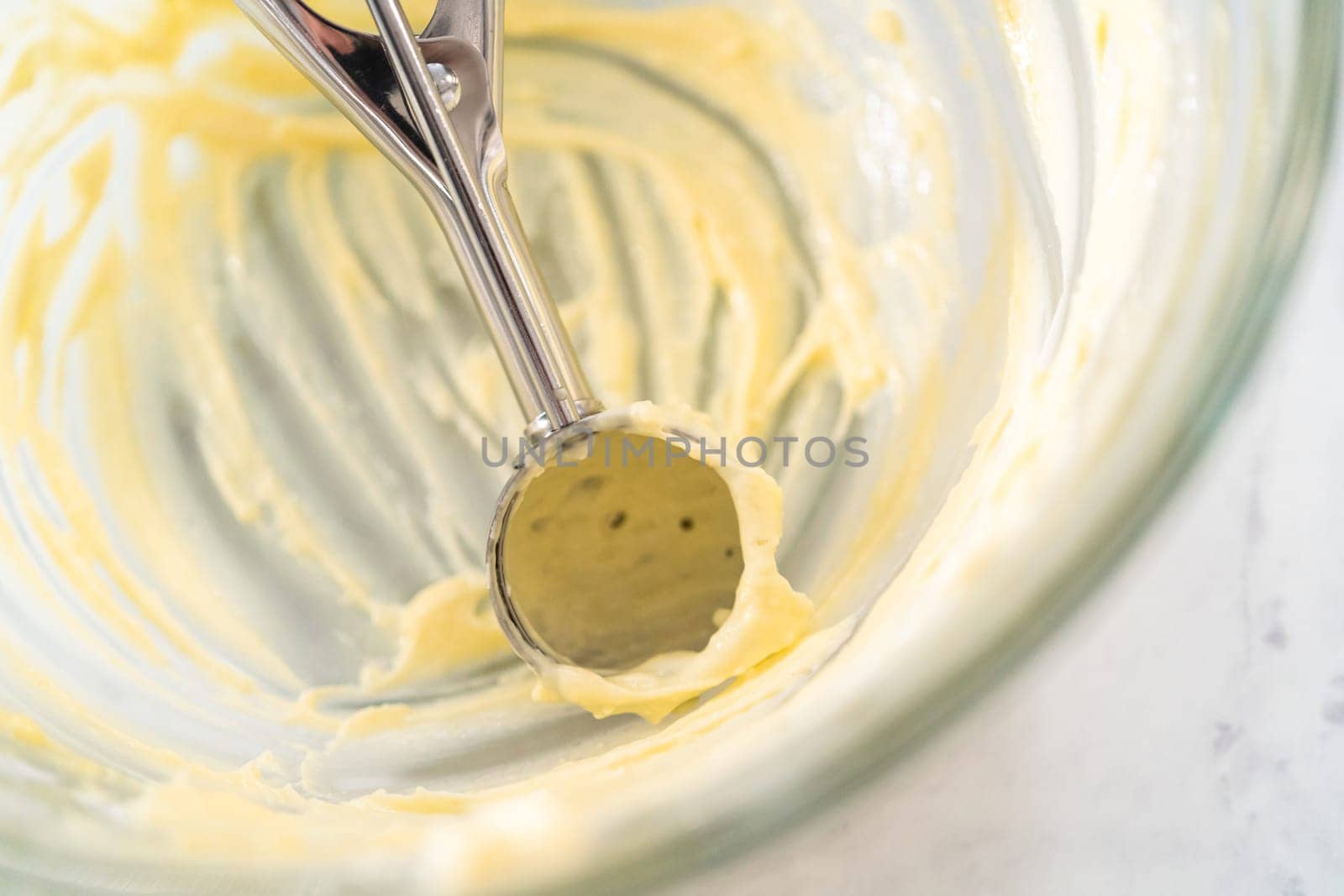 Filling metal bundt cake pan with cake butter to bake red velvet bundt cake with cream cheese glaze