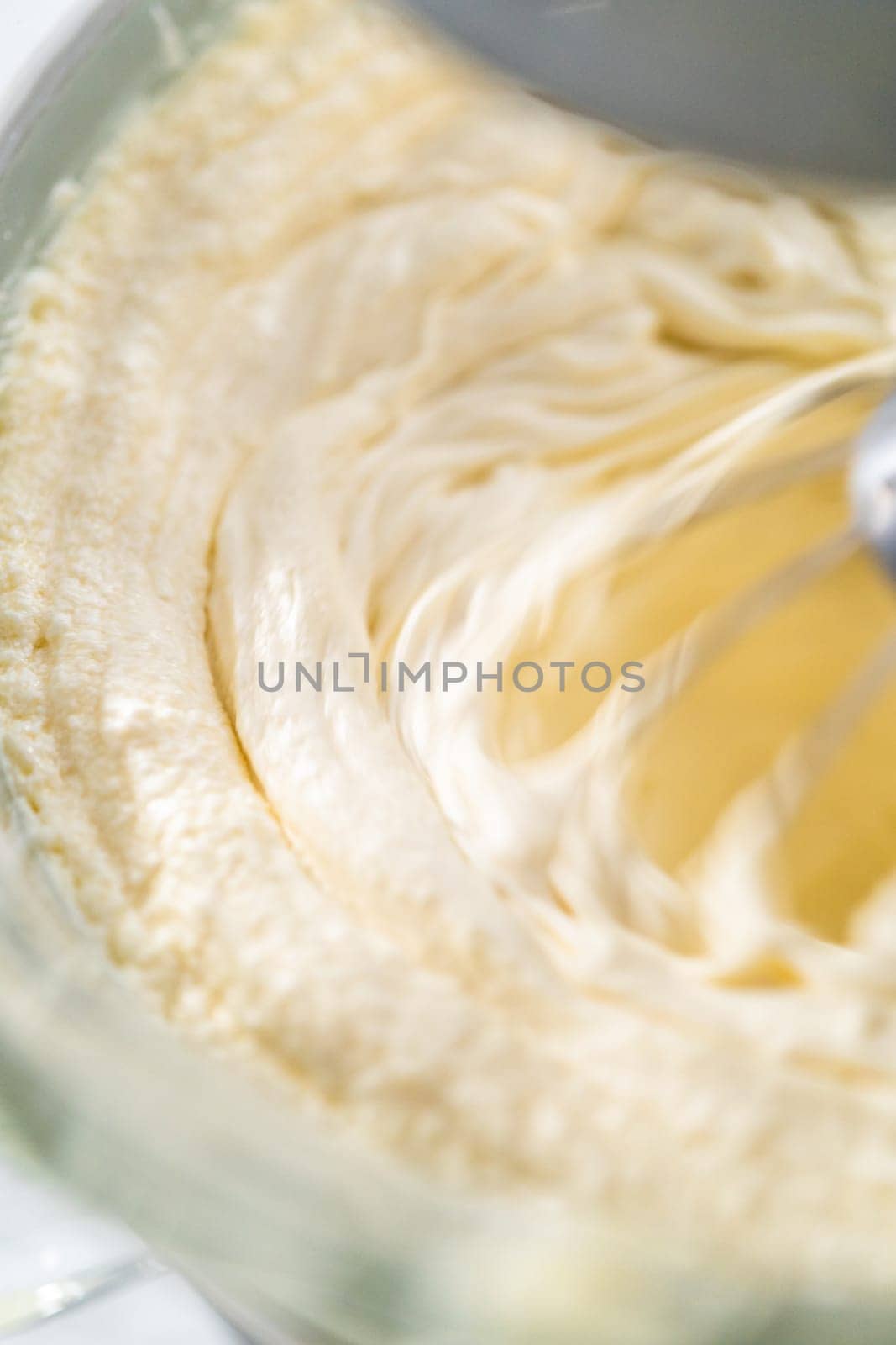 Whipping white ganache in kitchen mixer to make the white chocolate ganache frosting.