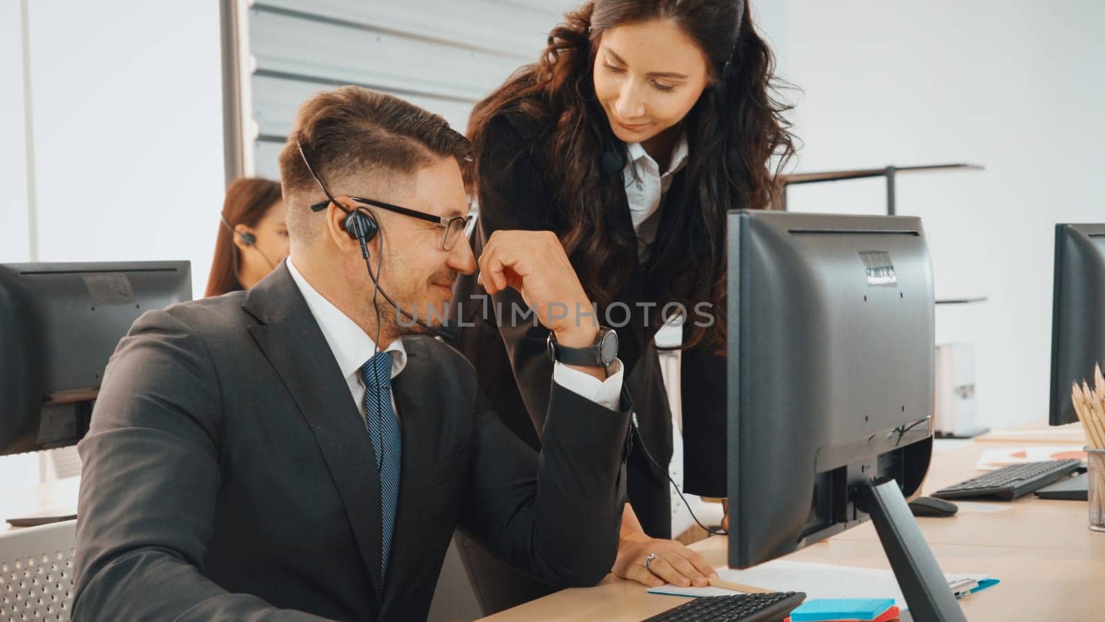 Business people wearing headset working in office to support remote customer or colleague. Call center, telemarketing, customer support agent provide service on telephone video conference call. Jivy