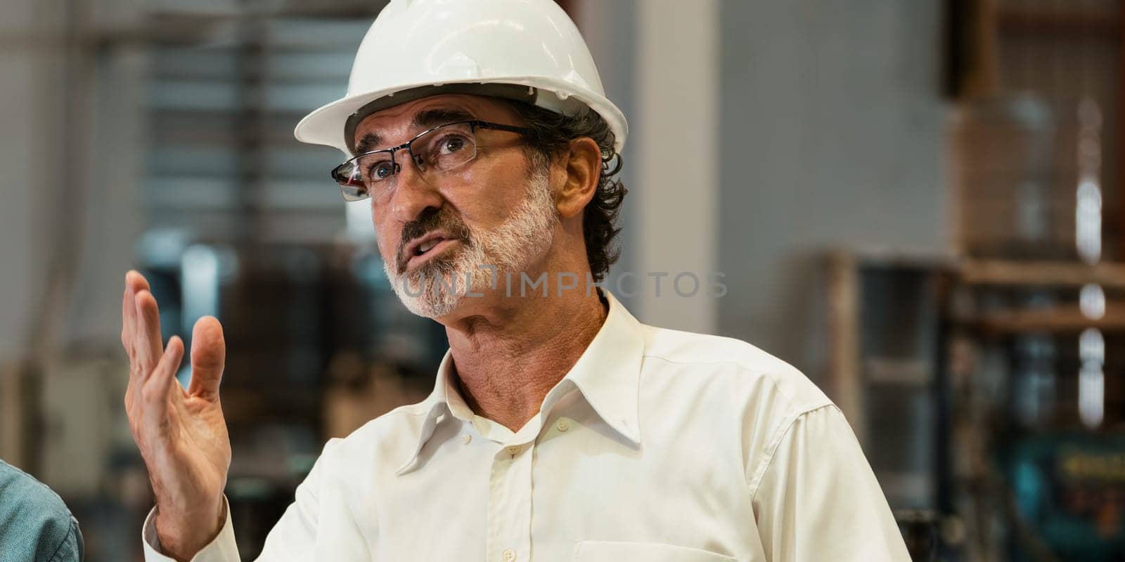 Factory manager or foreman in meeting with coworker in factory, briefing on heavy industrial machinery showcase leadership quality as engineering supervisor. Exemplifying