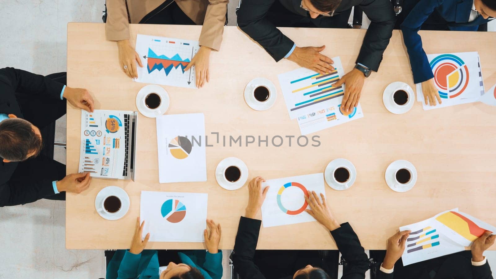 Business people group meeting shot from top view in office . Profession businesswomen, businessmen and office workers working in team conference with project planning document on meeting table . Jivy