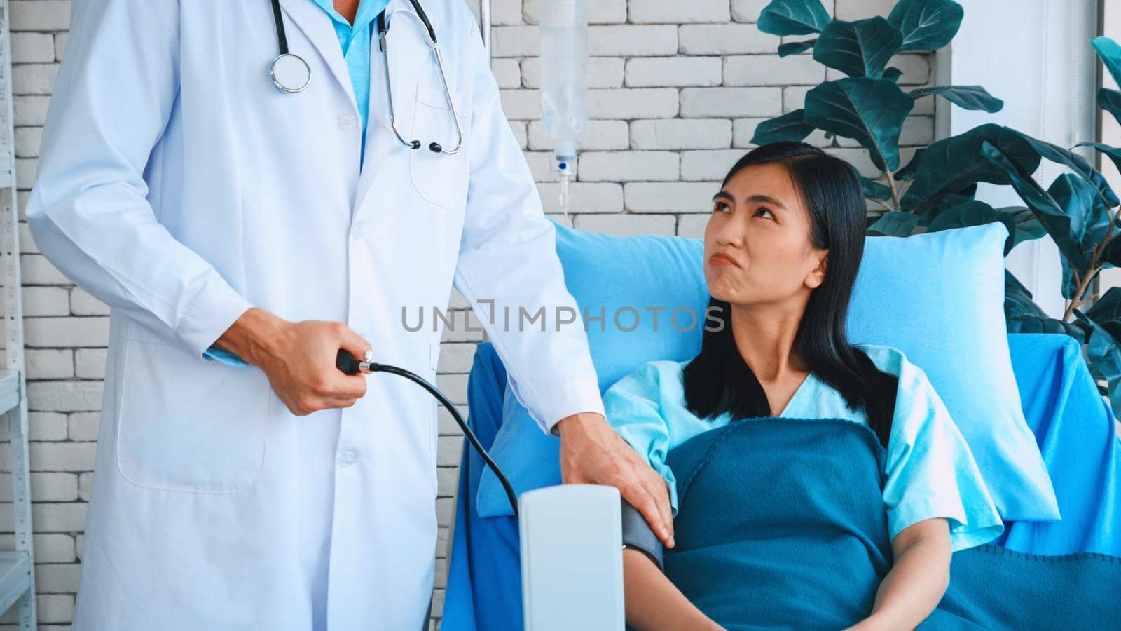 Doctor in professional uniform examining patient at hospital or medical clinic. Health care , medical and doctor staff service concept. Jivy