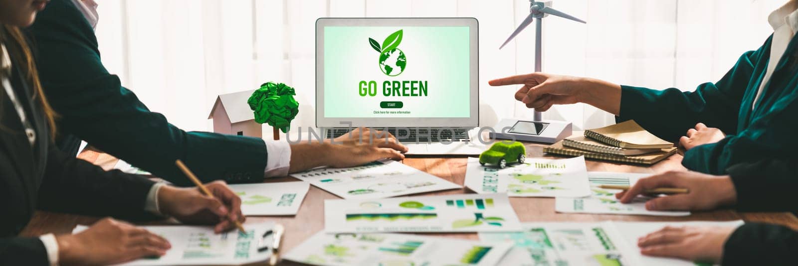 Go green ecology awareness campaign display on laptop on eco-friendly company meeting with business people implementing environmental protection for clean and sustainable future ecology. Trailblazing