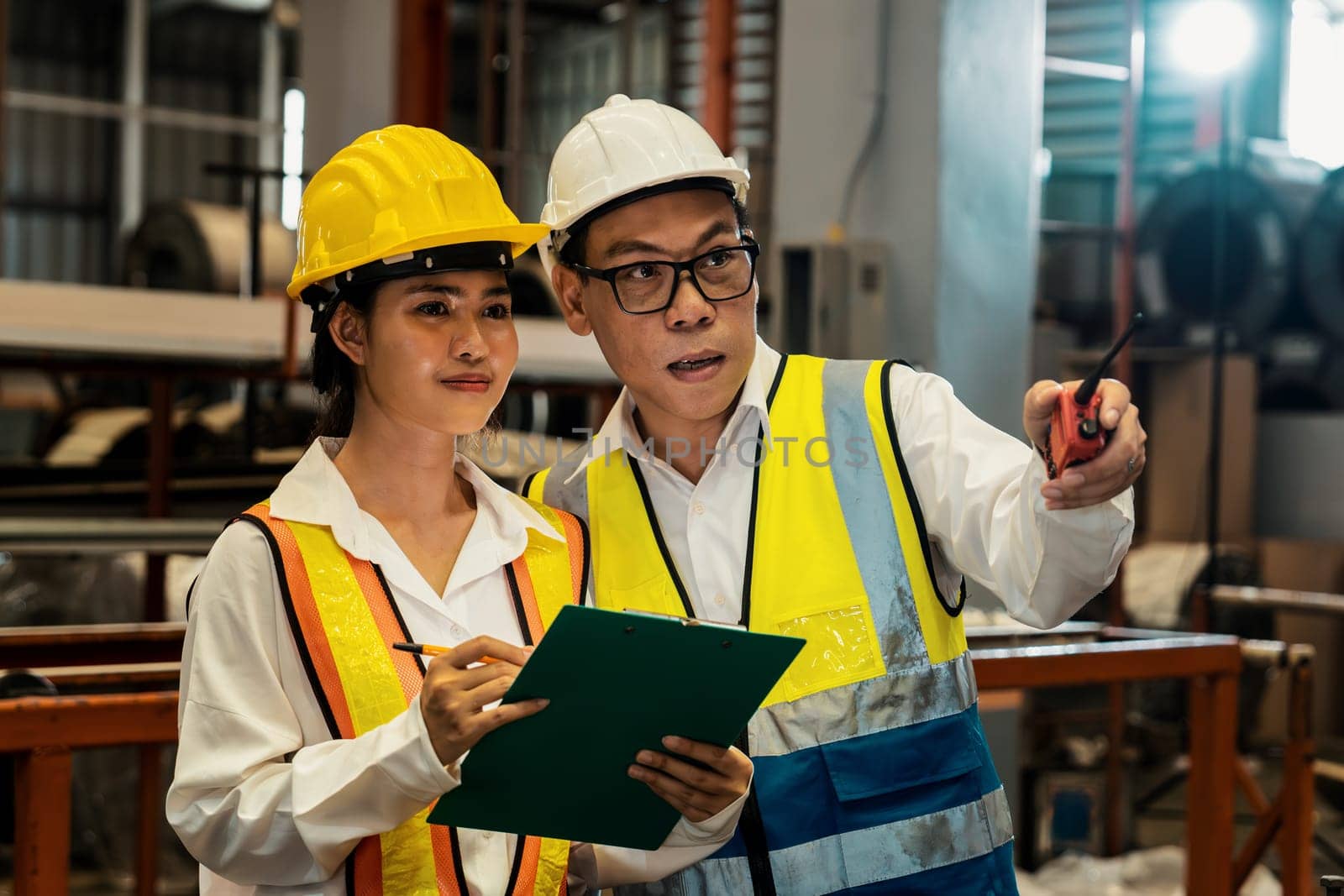 Factory engineer with assistant using laptop inspect factory. Pano Exemplifying by biancoblue