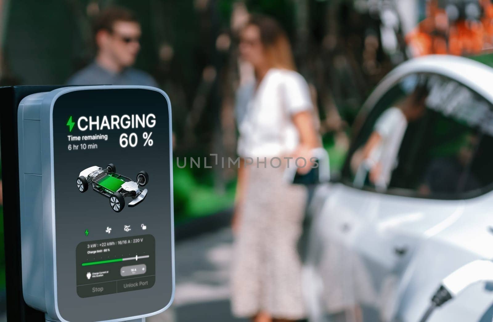 Young couple travel with EV electric car charging in green sustainable city outdoor garden in summer shows urban sustainability lifestyle by green clean rechargeable energy of electric vehicle innards