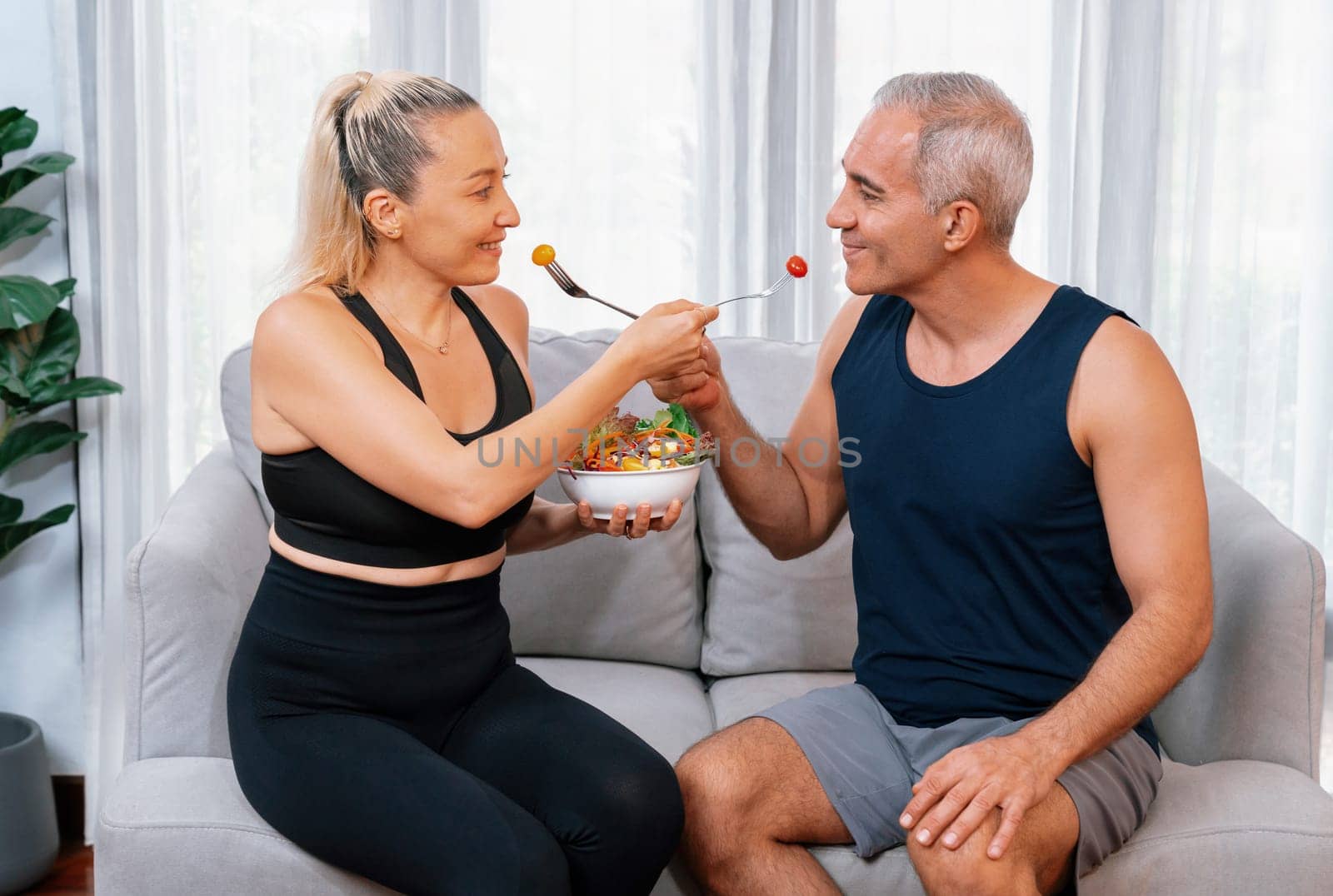 Healthy senior couple in sportswear taking selfie with vegan food. Clout by biancoblue