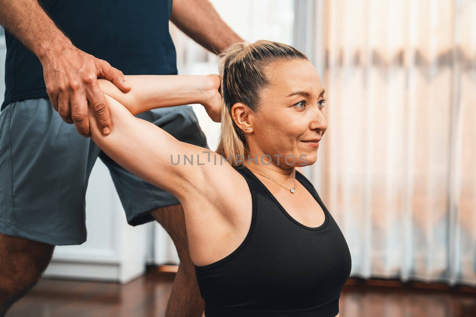 Happy active senior couple in sportswear being supportive and assist on yoga posture together at home. Healthy senior man and woman lifestyle with yoga exercise. Clout