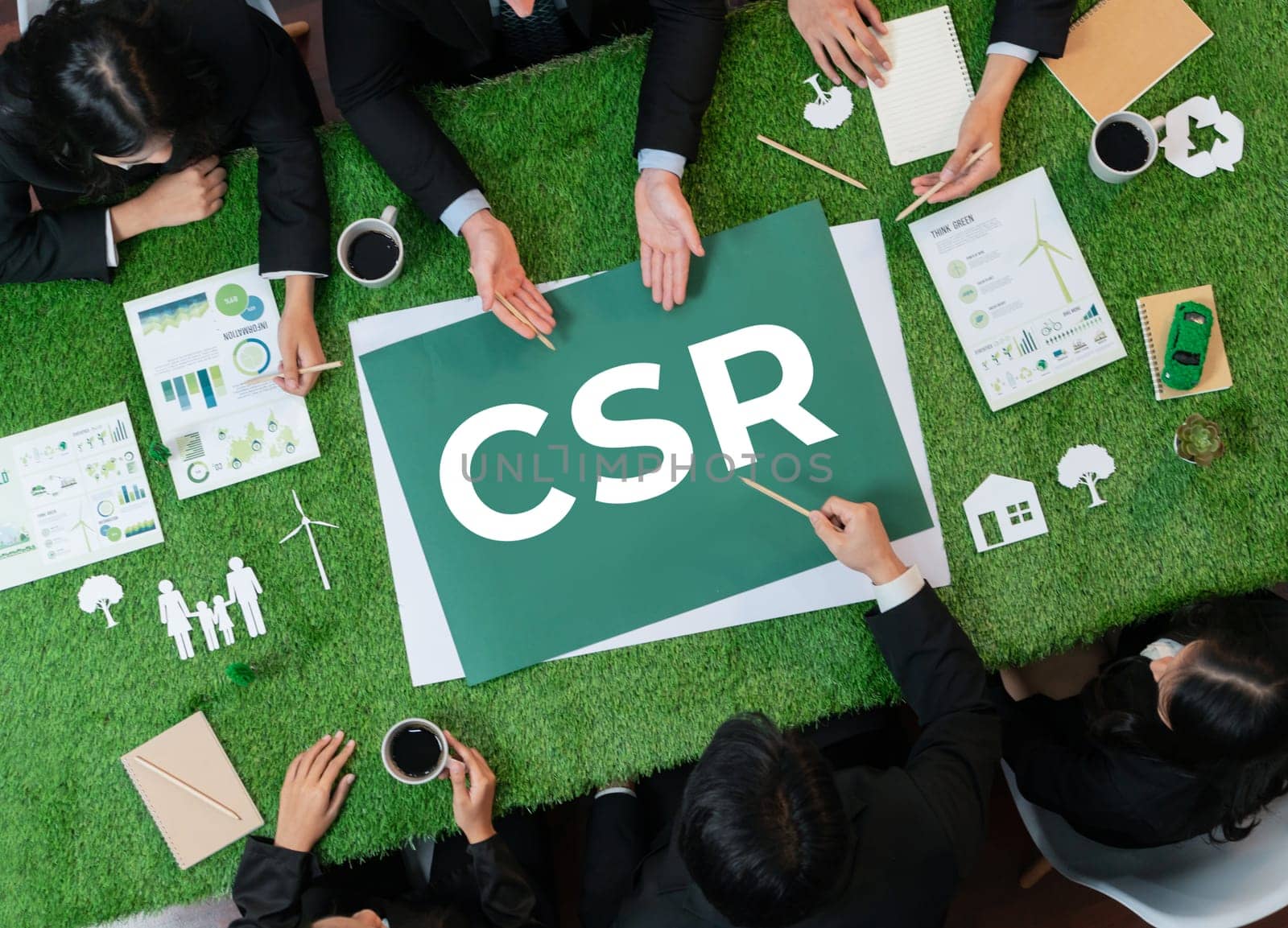 Top view panoramic CSR symbol on green grass table with business people planning for alternative energy utilization for greener sustainable Earth as corporate social responsibility. Quaint