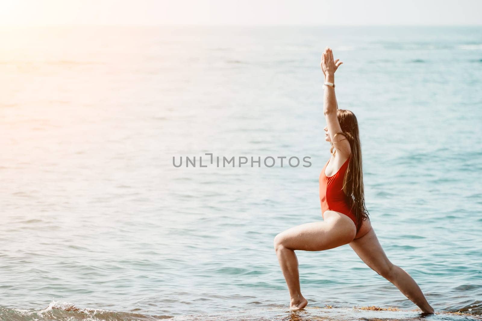 Woman sea yoga. Happy woman meditating in yoga pose on the beach, ocean and rock mountains. Motivation and inspirational fit and exercising. Healthy lifestyle outdoors in nature, fitness concept. by panophotograph