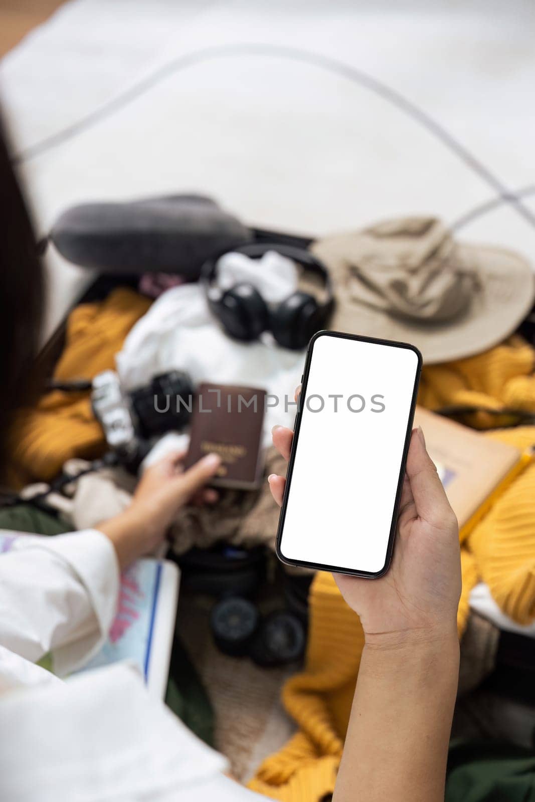 Mockup mobile phone with white screen, luggage in background by itchaznong