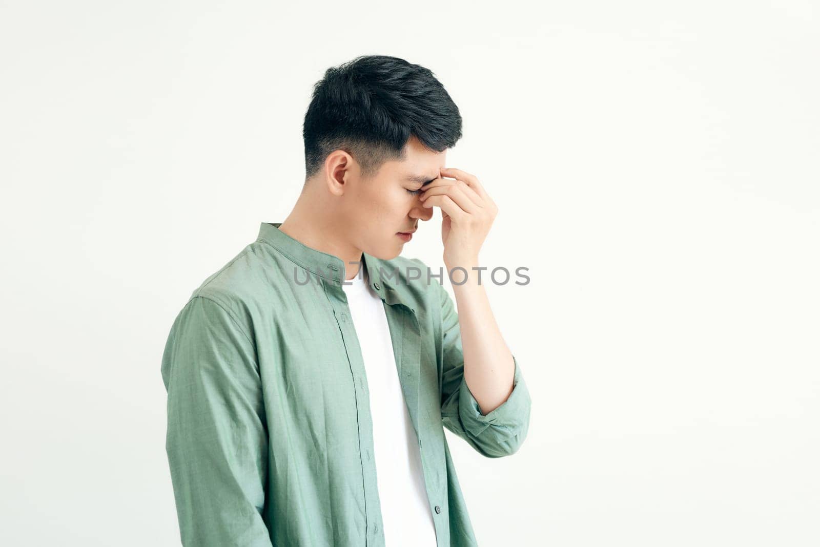 young and handsome southeast asian man having a light headache