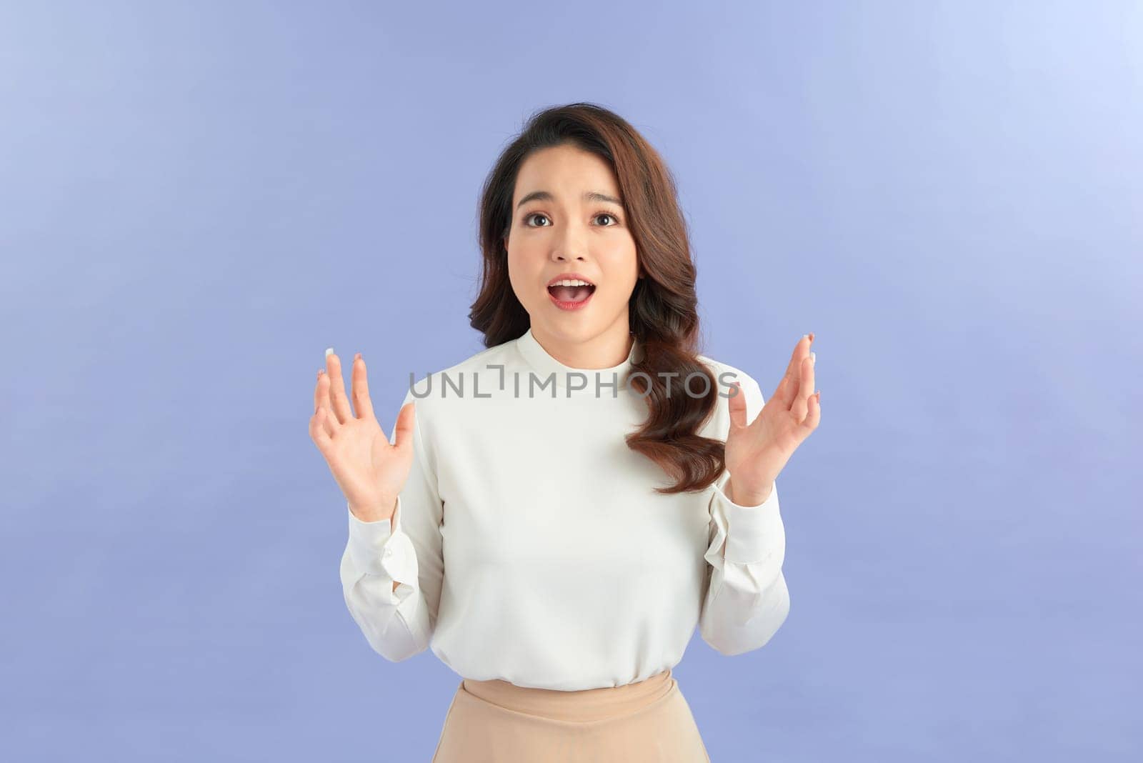 Asian girl is surprised she is excited on blue background