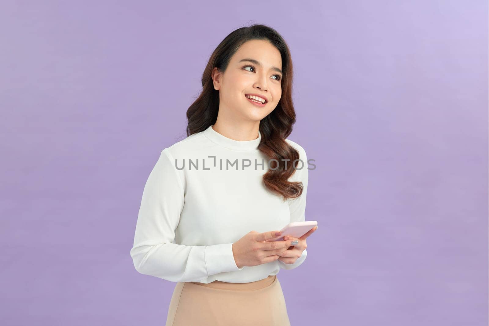 Young beautiful happy woman using smart phone.