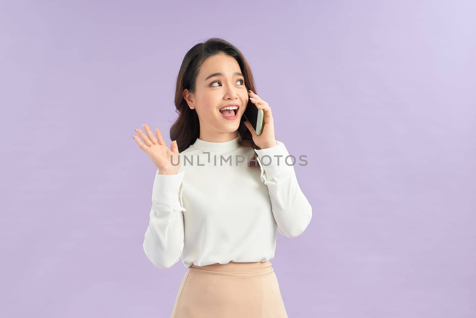 Happy Asian woman holding a smartphone and winning the prize.