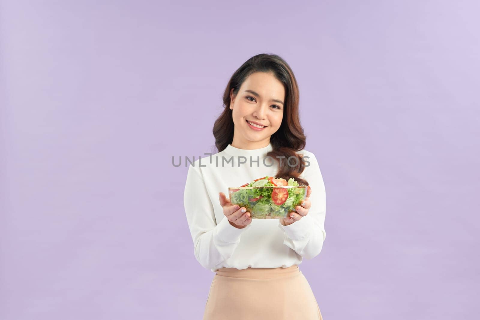 Beautiful young asian eating salad with big smile happy beaming face 