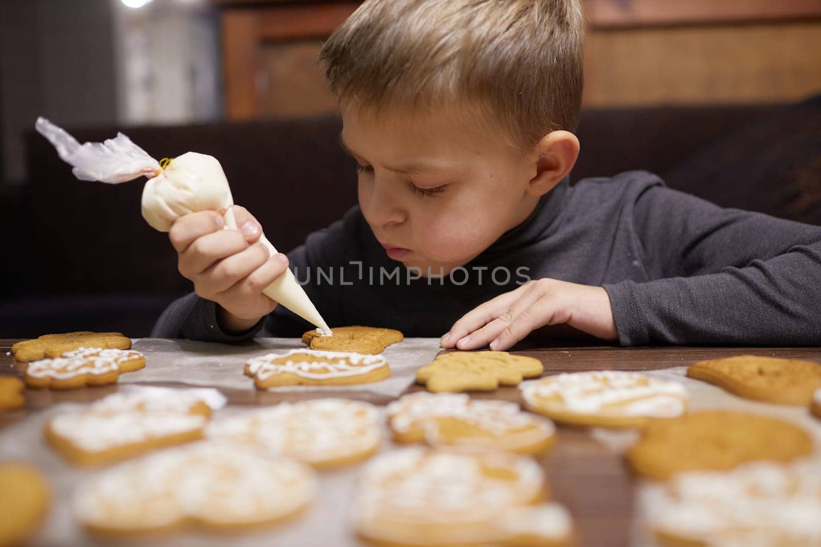 boy preparing Christmas gingerbread and cookies, homemade cookies, baking at home