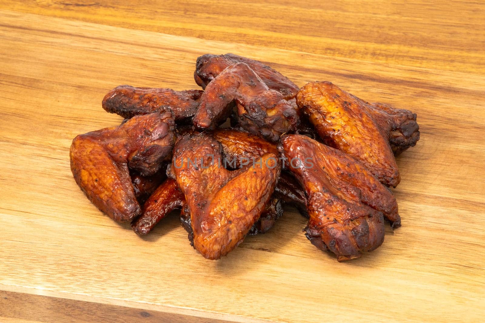 A mouthwatering and tempting pile of crispy chicken wings, perfect for appetizers or delightful game day snacks