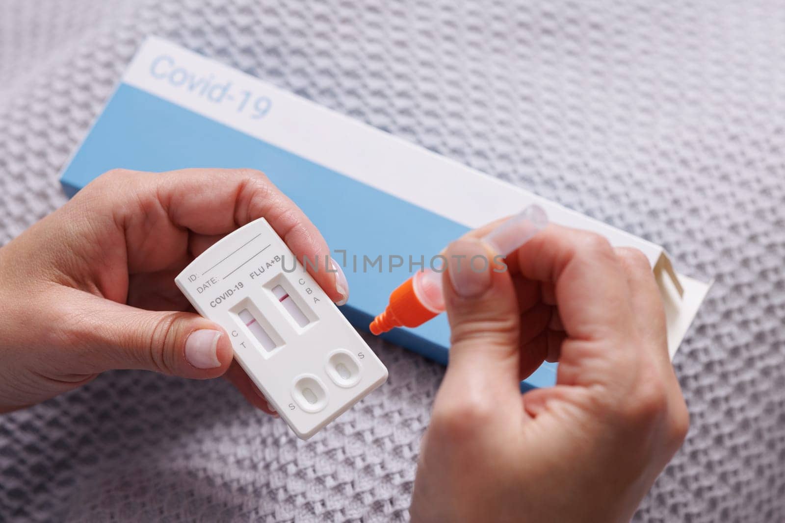 woman tests herself for new coronavirus strain at home, test for detection of covid-19 antigens and flu viruses, diagnosis of disease