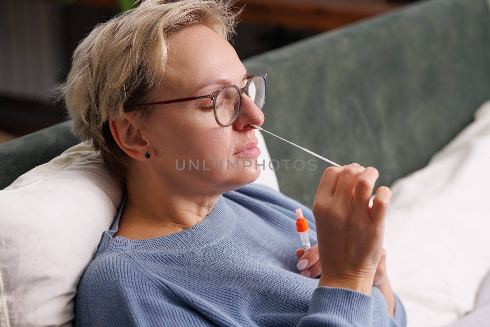 woman tests herself for new coronavirus strain at home, test for detection of covid-19 antigens and flu viruses, diagnosis of disease