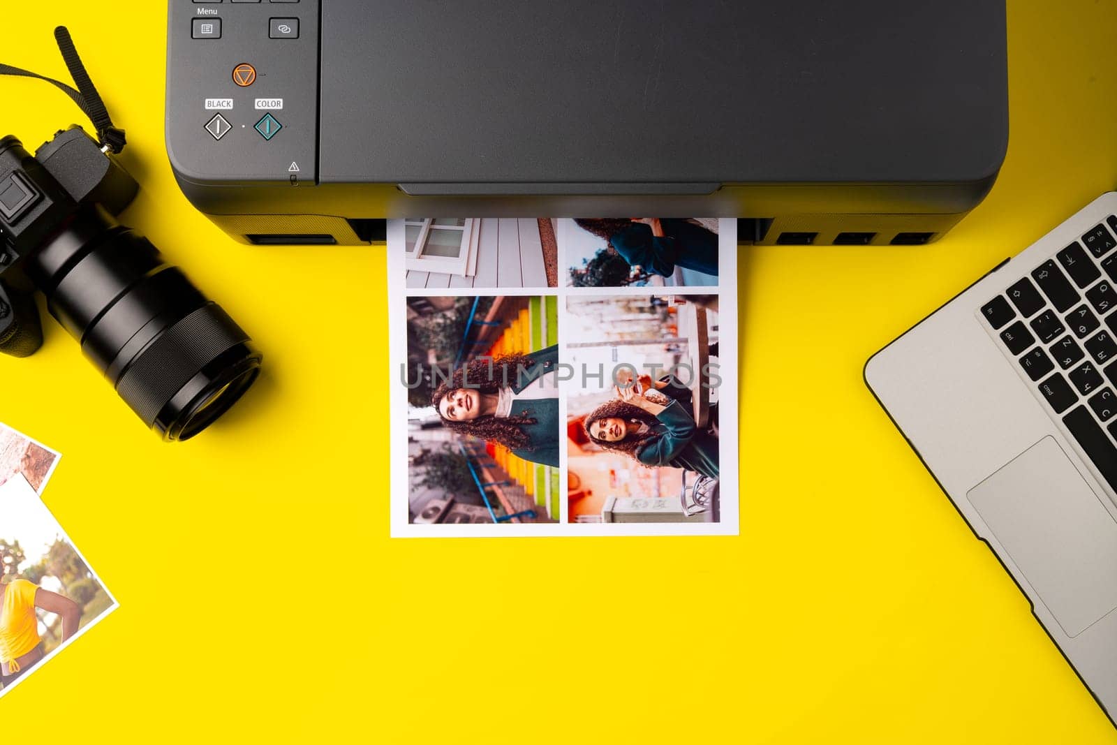 Printer printing colorful photos of people close up, yellow background, studio shot