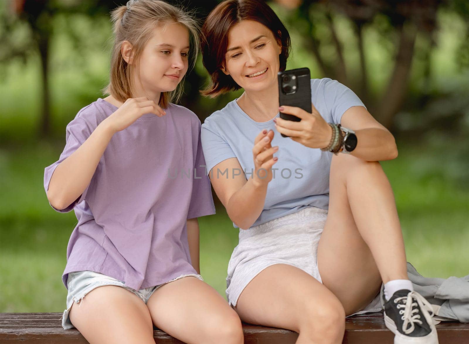 Mother And Girl Taking A Selfie With A Smartphone On A Happy Summer Day