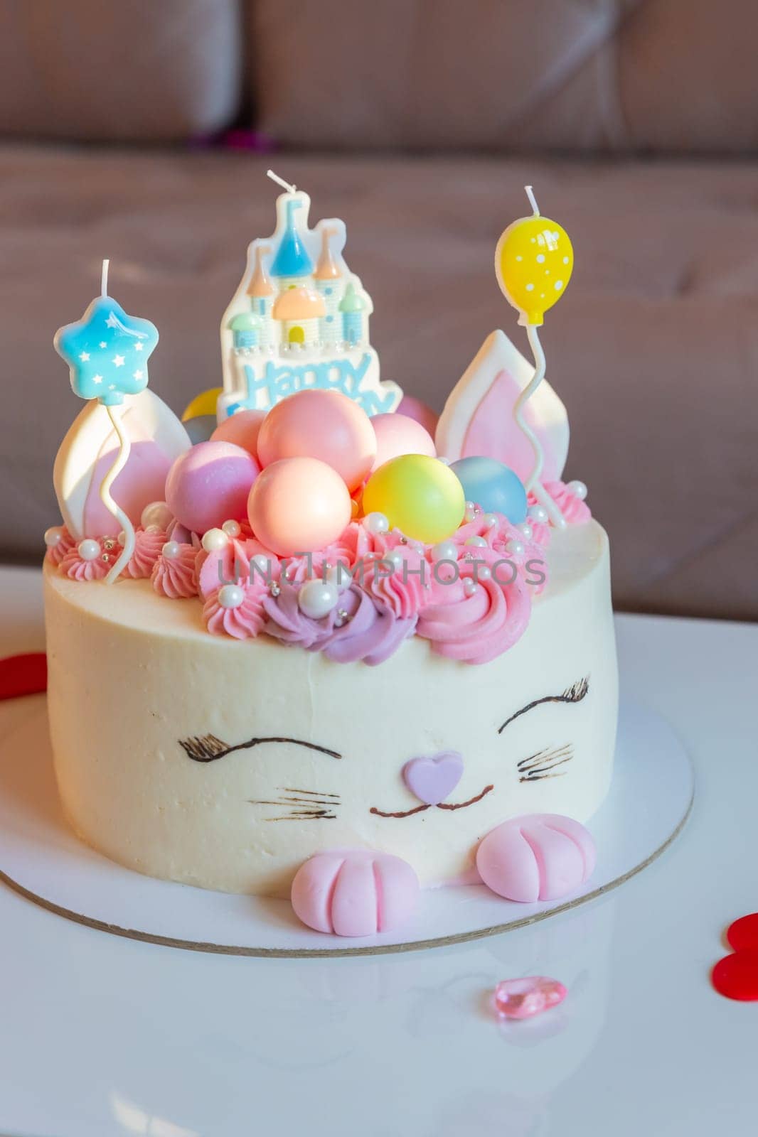 Kids birthday party decoration. Colorful cake with candles.
