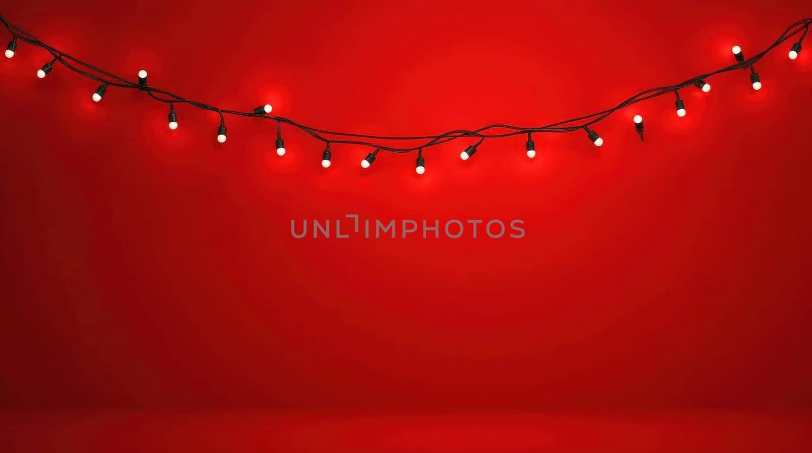 Christmas lights are hanging on a red background with falling snow