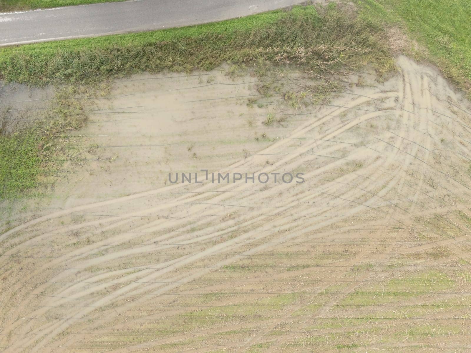 Overhead Aerial view of a flooded fields showcasing the impact of unusual heavy rainfall on rural landscapes during autumn