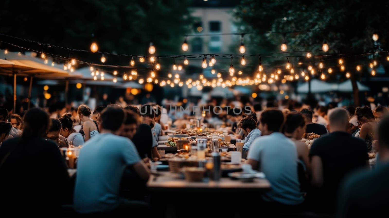 A vibrant aerial shot capturing a crowded street food market at night. Festive lights illuminate tables filled with diners enjoying a variety of delicious cuisines.
