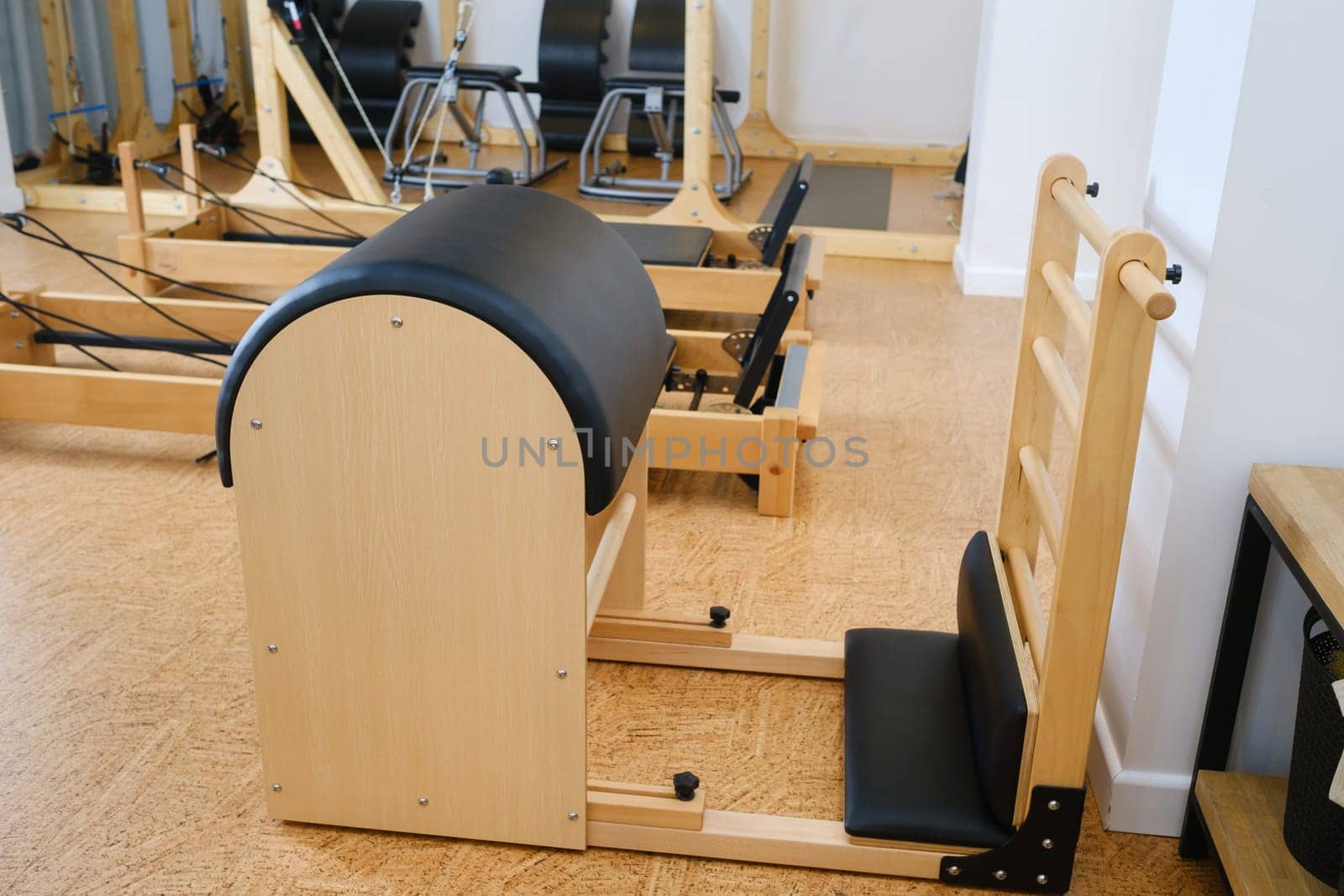 Pilates simulator is a barrel in the yoga room. Pilates equipment.
