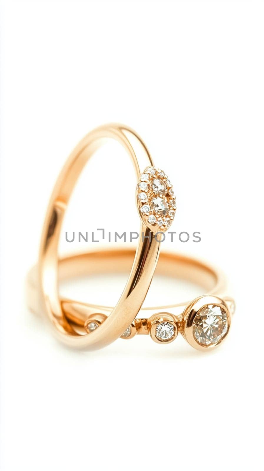 Two simple gold wedding rings are laying on white cloth, ready for the couple to exchange during their wedding ceremony