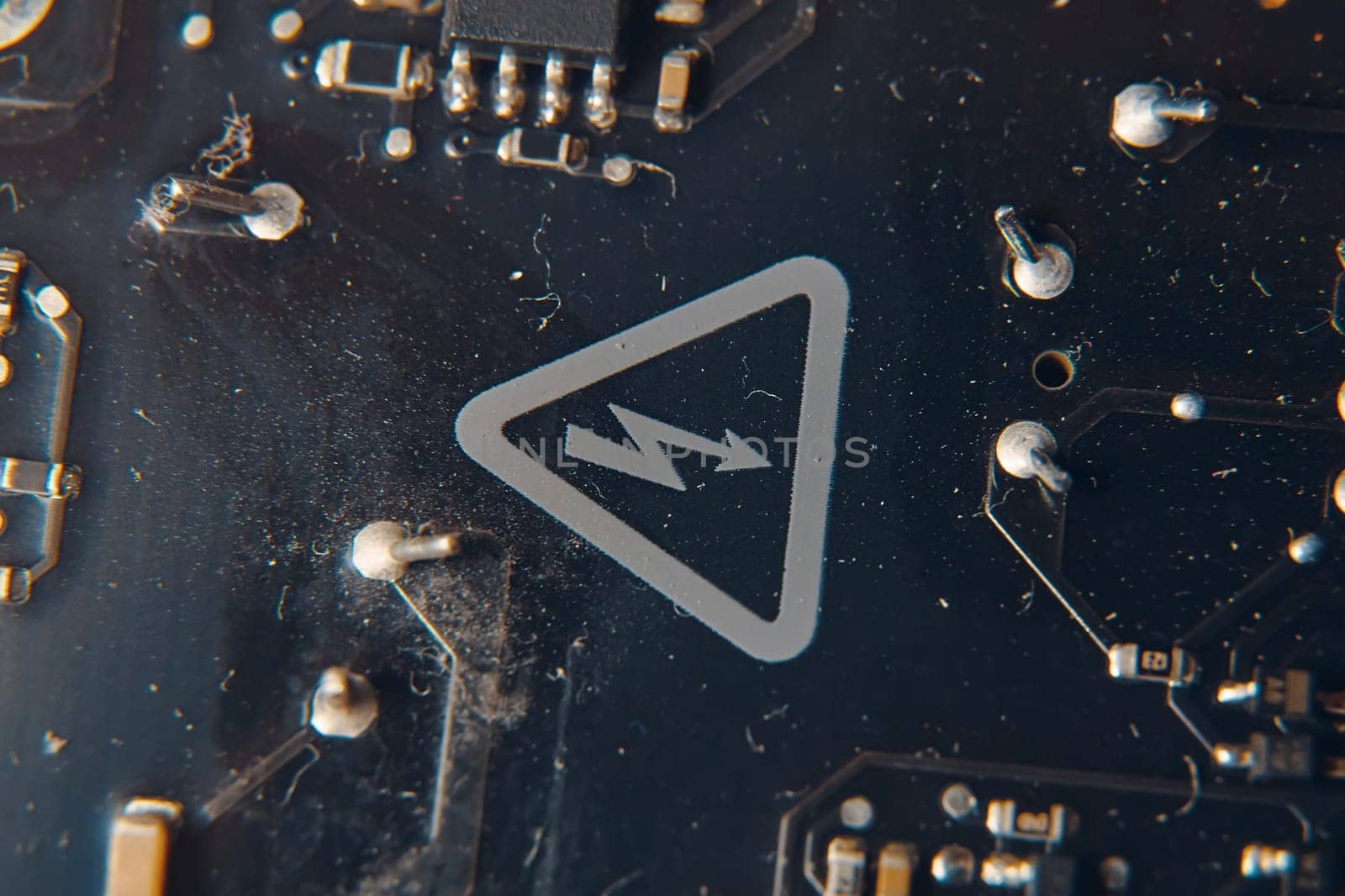 A detailed view showcasing a vibrant circuit board that prominently features a warning symbol indicating electricity