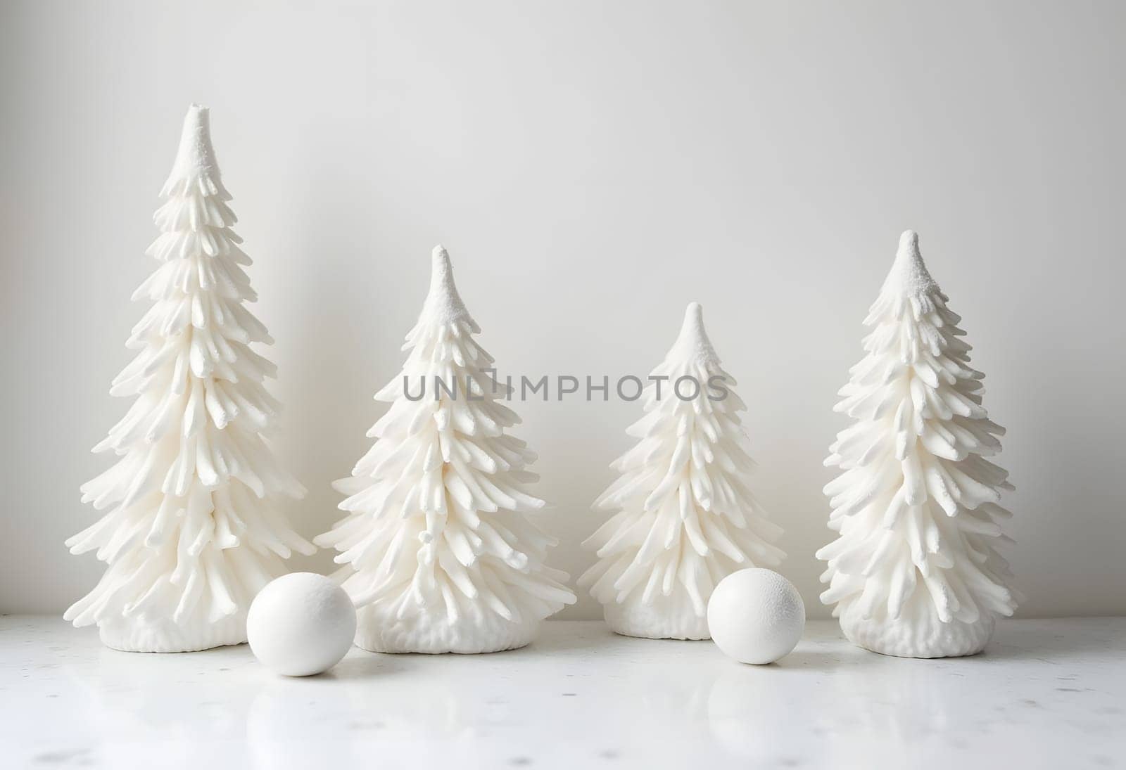 White decorative spruce trees in Scandinavian minimalism style on a white background. High quality photo