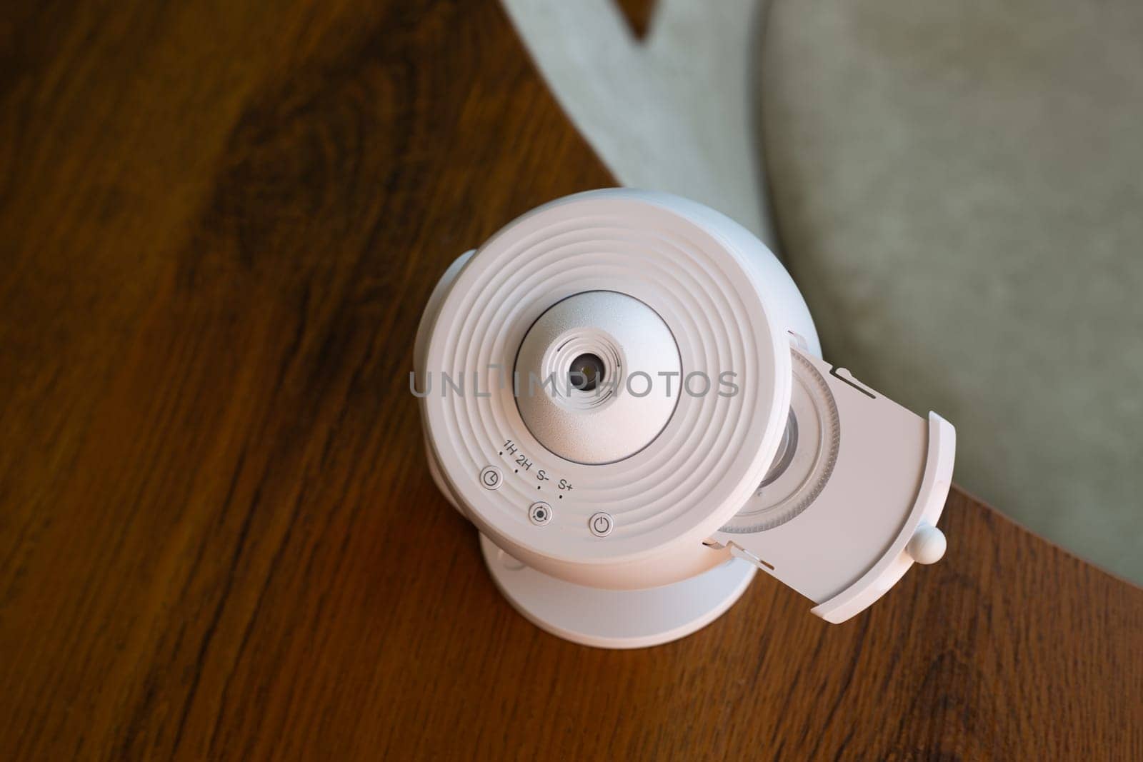 Home galaxy projector with replaceable cartridges with different planets and stars for space exploration at home, projecting the starry sky onto ceiling of room
